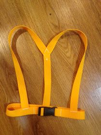 a pair of yellow suspenders sitting on top of a wooden floor