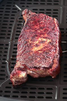 a piece of steak sitting on top of a grill