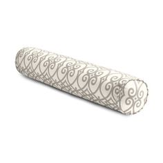 a pink and white roll pillow on a white background with an intricate design in the middle