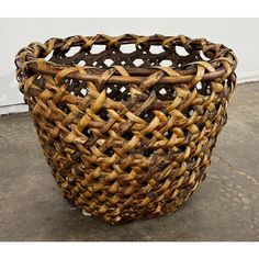 a woven basket sitting on top of a cement floor