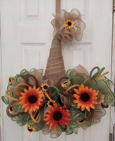 a door wreath with sunflowers on it