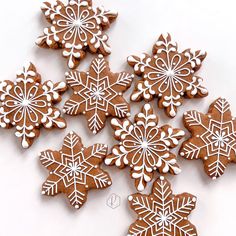 some very pretty looking cookies with snowflakes on them