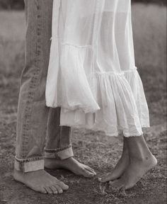 two people standing next to each other in the grass