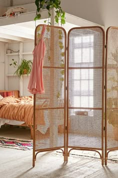 the room divider is made out of bamboo and has an open door to it