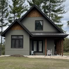 a gray house with brown trim and windows