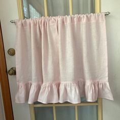 a pink curtain hanging on the side of a door