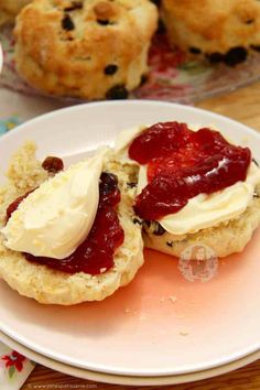 scones filled with jam and butter on a plate