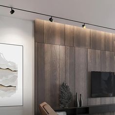 a living room filled with furniture and a flat screen tv on top of a wooden wall