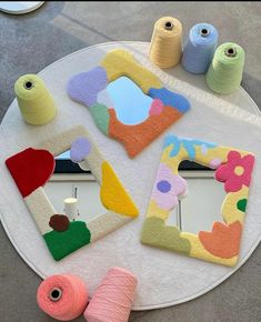 the table is covered with different colored yarns and various items that are sitting on top of it