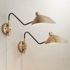 two wall lights on the side of a white wall