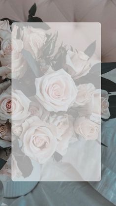 a bouquet of white roses sitting on top of a blue bed sheet with text overlay