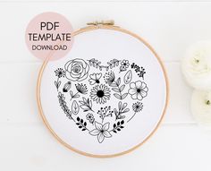 an embroidery pattern with flowers in the shape of a heart