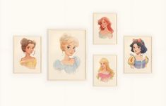 four disney princesses are hanging on the wall