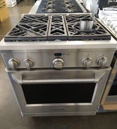 a stainless steel stove and oven in a store