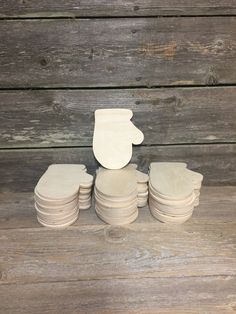 a stack of white plates sitting on top of a wooden table next to each other