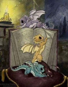 an open book sitting on top of a bed next to a dragon and another animal