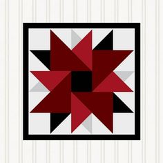 a red and black star quilt pattern on a white striped wall hanging in a room