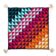 a multicolored blanket with tassels on it