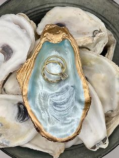 an oyster shell with a ring in it