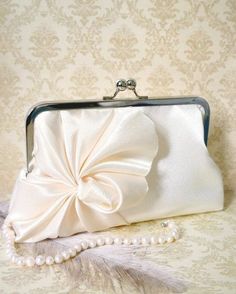 a white purse with a large bow on it