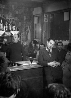 an old black and white photo of people in a bar