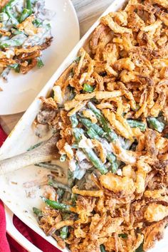 a casserole dish filled with green beans and other toppings on a white plate