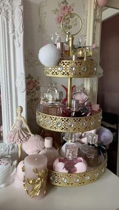 three tiered cake stand with pink and gold decorations