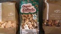 two bags of organic pistachio nuts sitting next to each other on a counter