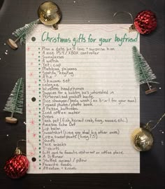 a christmas gift list with ornaments and bells around it on top of a piece of paper