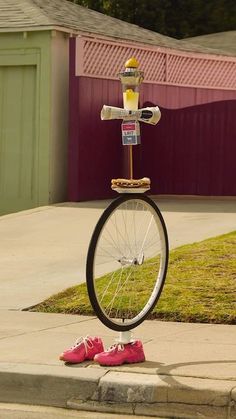 there is a bike that has been placed on top of a pole with a fire hydrant attached to it