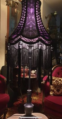 a purple lamp sitting on top of a table