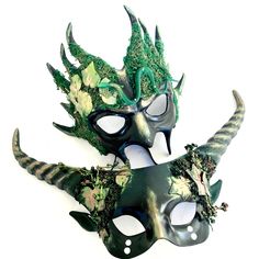 two masks with horns and flowers on them