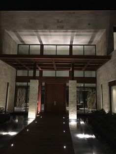 the entrance to a modern house lit up at night