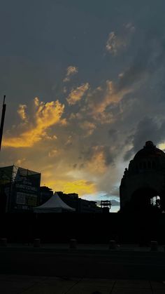 the sun is setting behind some buildings