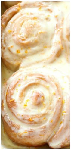 some food that is in a pan on a table with oranges and white icing