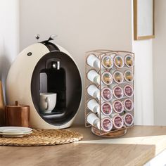 an espresso machine sitting on top of a counter next to plates and cups