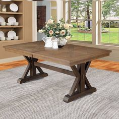 a dining room table with two vases on it