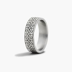 a wedding ring with an intricate design on the outside and inside, against a white background