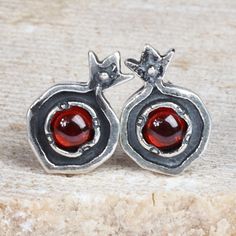 Inspired by pomegranates and their traditional symbolism, Levon Kuchatyan creates this exquisite homage to Armenia's classic arts. Crafted from sterling silver, these button earrings feature a classic pomegranate shape accented with natural garnet gems, whose vibrant red hue is a symbol of passion, completing the fruit's symbolism of romance and fertility. Pomegranate Bracelet, Pomegranate Jewelry Handmade, Pomegranate Gold Jewelry, Gold Pomegranate Necklace, Pomegranate Pendant, Eclectic Outfits, Pomegranate Jewelry, Silversmith Jewellery, Garnet Gem