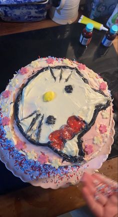 a hello kitty birthday cake with sprinkles and icing on the top