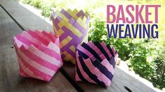 three paper baskets sitting on top of a wooden table with the words basket weaving written above them