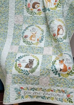 a quilted blanket with woodland animals on it