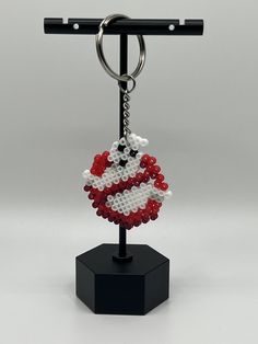 an american flag beaded keychain on a black stand