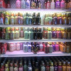 the shelves are filled with many different kinds of drinks