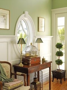 a living room filled with furniture and a birdcage on top of a table