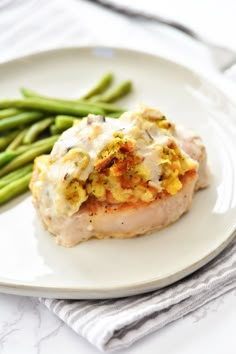 a white plate topped with meat and green beans