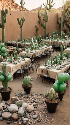 an outdoor dining area with tables, chairs and cacti on the tablecloths