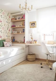 a bedroom with a bed, desk and chair next to a wallpapered wall