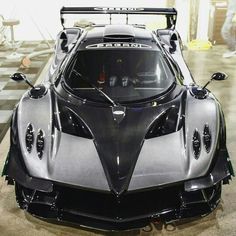 a silver and black sports car parked in a garage