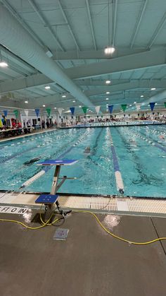 an indoor swimming pool with people in it